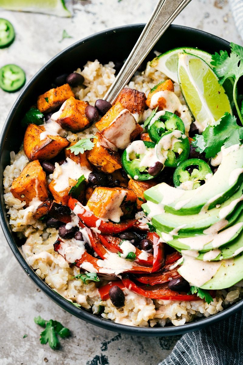 SWEET POTATO BURRITO BOWL! A delicious and simple to make veggie burrito bowl -- brown rice, seasoned & roasted sweet potatoes + bell peppers, black beans, and avocado with the most incredible chipotle lime sauce. Recipe via chelseasmessyapron.com