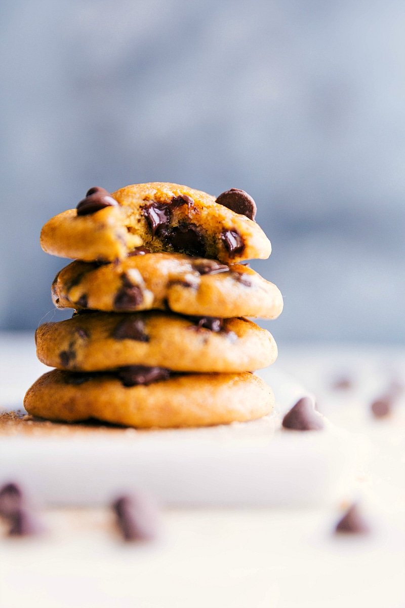 Stacked small batch pumpkin cookies with the top one featuring a missing bite, showcasing their texture.