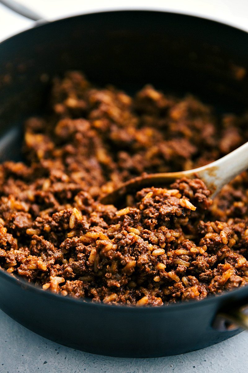 Skillet of ground beef mixture with spices, garlic, and rice