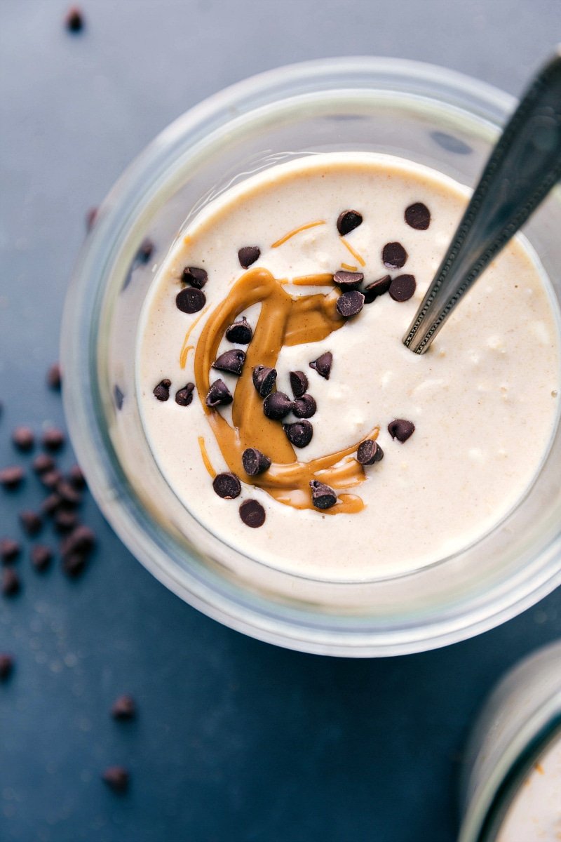 Finished peanut butter cheesecake overnight oats, adorned with a gorgeous peanut butter swirl and chocolate chips on top.