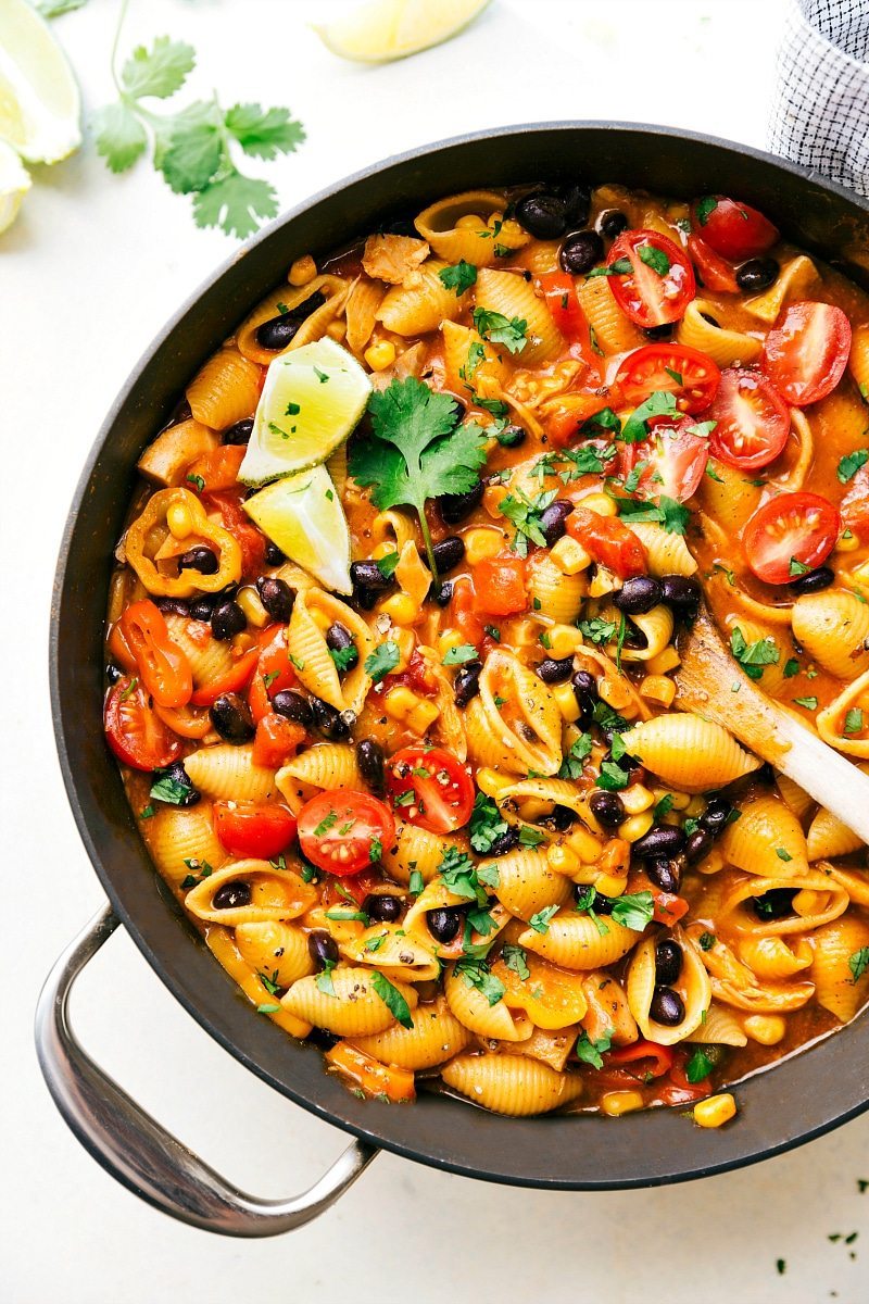 An easy ONE SKILLET chicken enchilada pasta dish that comes together in less than thirty minutes. A meal the whole family will love! via chelseasmessyapron.com