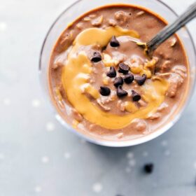 Peanut butter overnight oats, ready to be enjoyed on the go, with a peanut butter swirl mixed in and topped with chocolate chips.