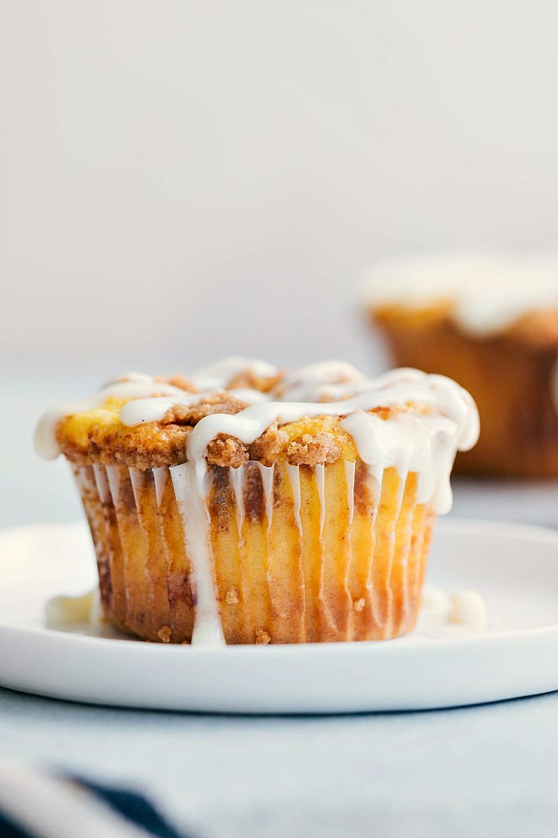 Close-up of one cinnamon roll cupcake on a white plate. 