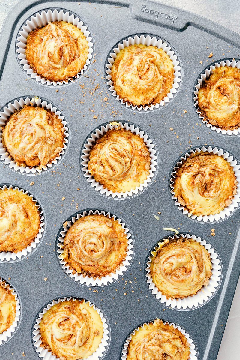 Cinnamon roll cupcakes in a cupcake cooking sheet.