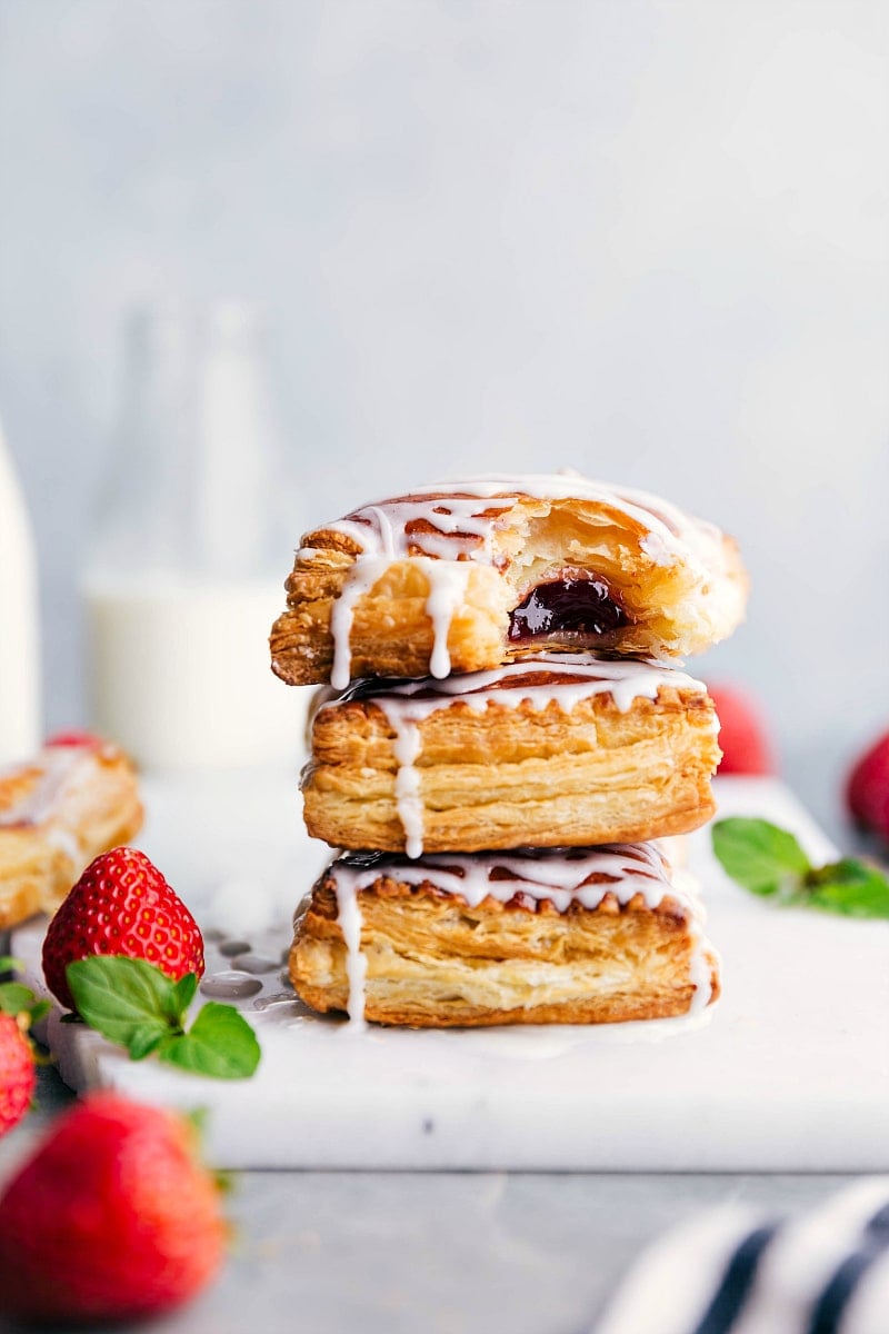 Image of the freshly baked Toaster Strudels stacked on top of each other with a bite out of the top one.
