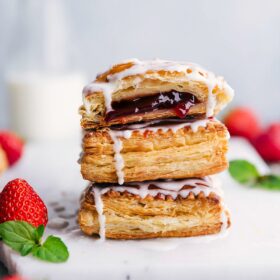 Stacked Toaster Strudels with a side of fresh strawberries.
