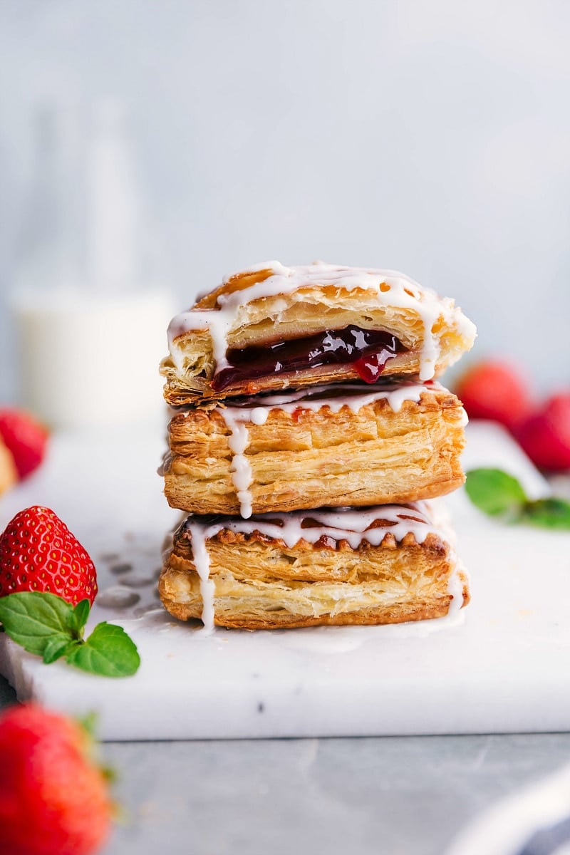 Image of Toaster Strudels stacked on top of each other, with fresh strawberries on the side.
