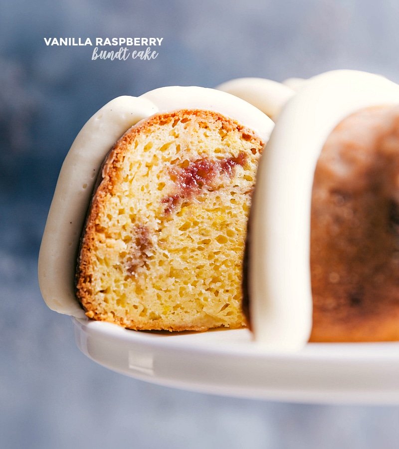 Vanilla raspberry bundt cake with a slice being served, showcasing its deliciousness.