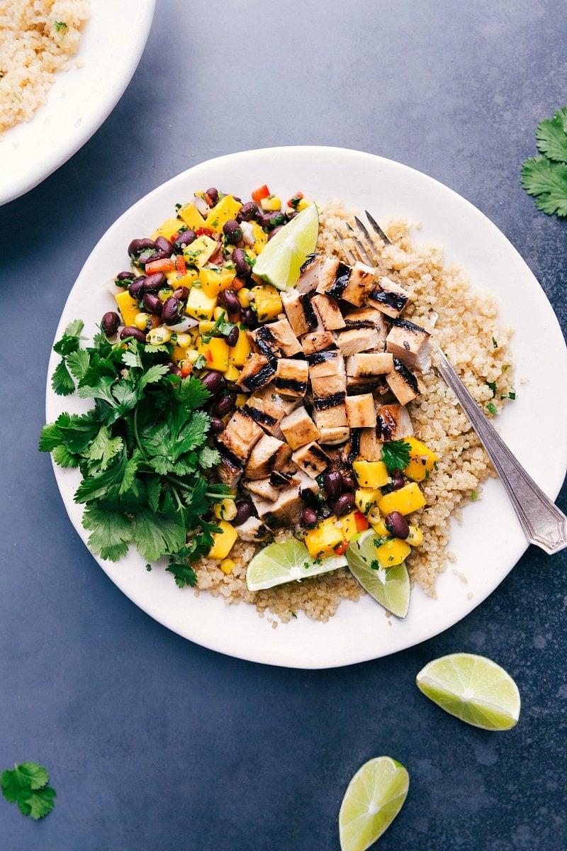 Overhead image of Quinoa Chicken Bowl with fresh mango salsa and cilantro on the side.