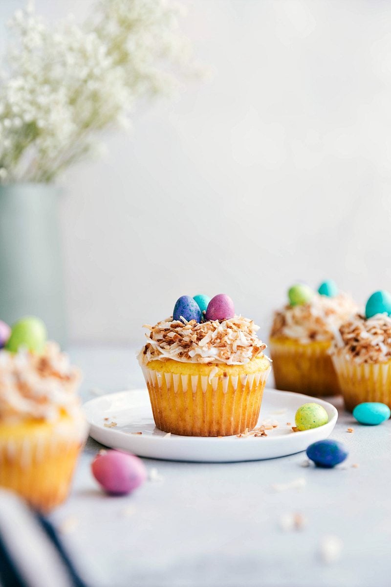 Yellow cupcakes topped with the best cream cheese frosting, toasted coconut, and M&Ms to create the cutest (and easiest) Easter treat! These bird's nest cupcakes are so simple to make. chelseasmessyapron.com 4 bird's nest Easter cupcakes
