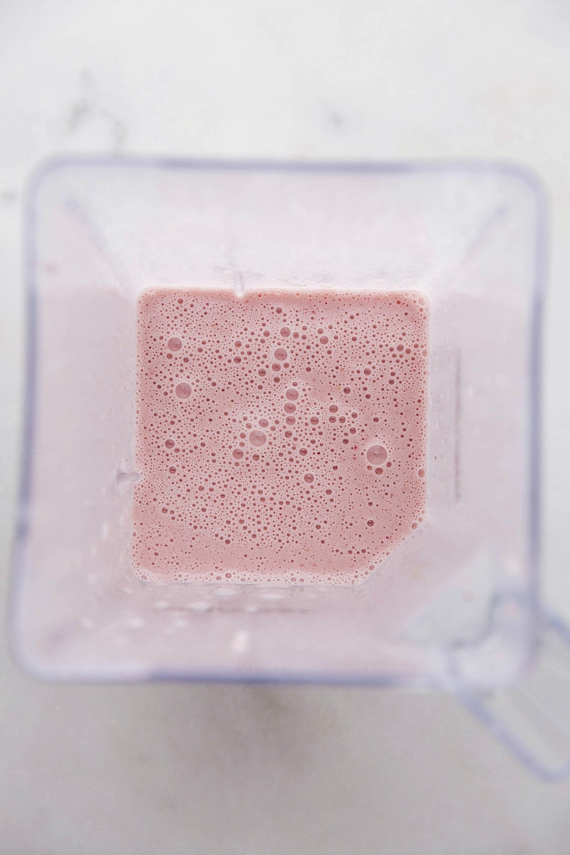 Overhead process shot of the blended ingredients for Strawberry Banana Smoothies.