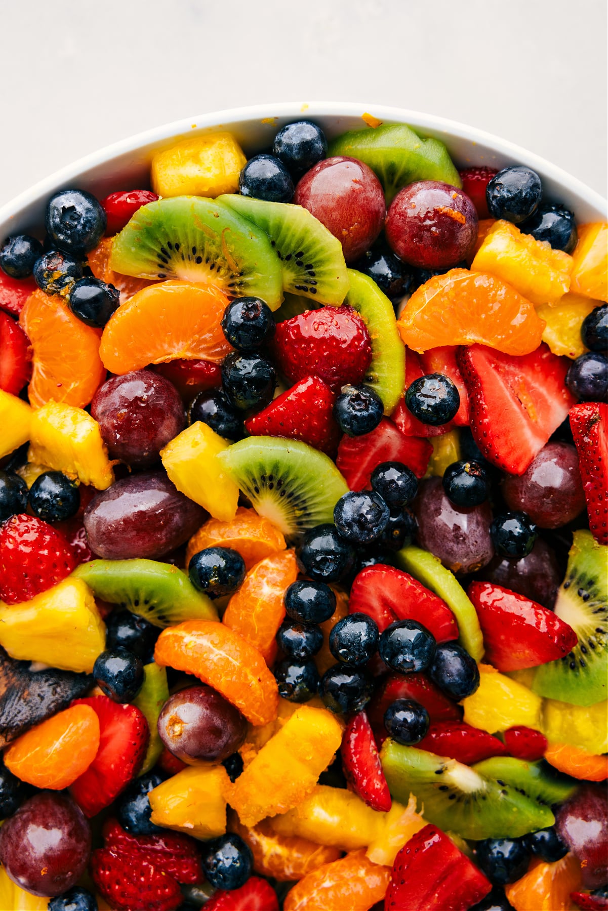 The dressed, easy fruit salad in a bowl ready to be enjoyed.