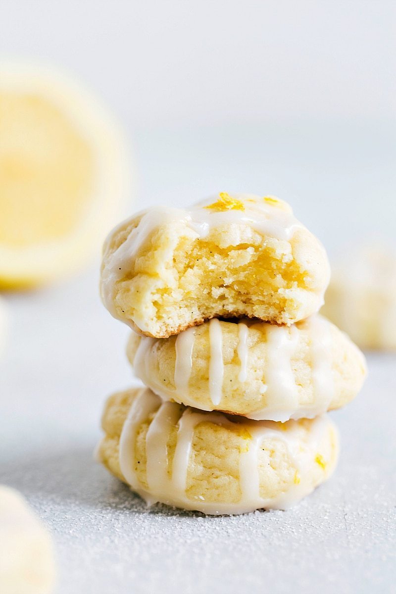 A stack of three Lemon Cheesecake Cookies with a bite taken out of the top cookie.