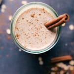 Oatmeal Smoothie in a cup with a stick of cinnamon in it.