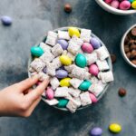 Puppy Chow with a child's hand grabbing a piece.