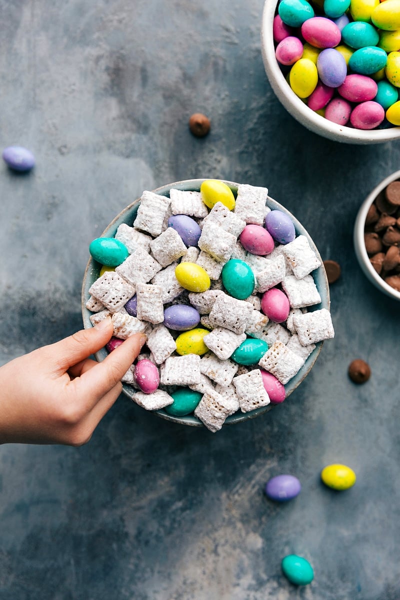 Overhead photo of Puppy Chow with a child's hand grabbing a piece.