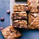 Warm, chewy soft-baked oatmeal breakfast bars, cut into squares and ready to be eaten.