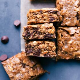 Warm, chewy soft-baked oatmeal breakfast bars, cut into squares and ready to be eaten.