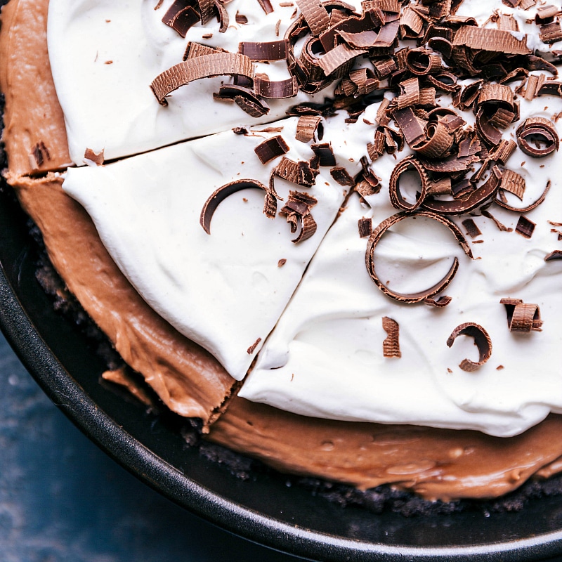 Tempting nutella cookie pie, with a clean cut indicating a slice ready to be lifted out, showcasing its luscious layers.