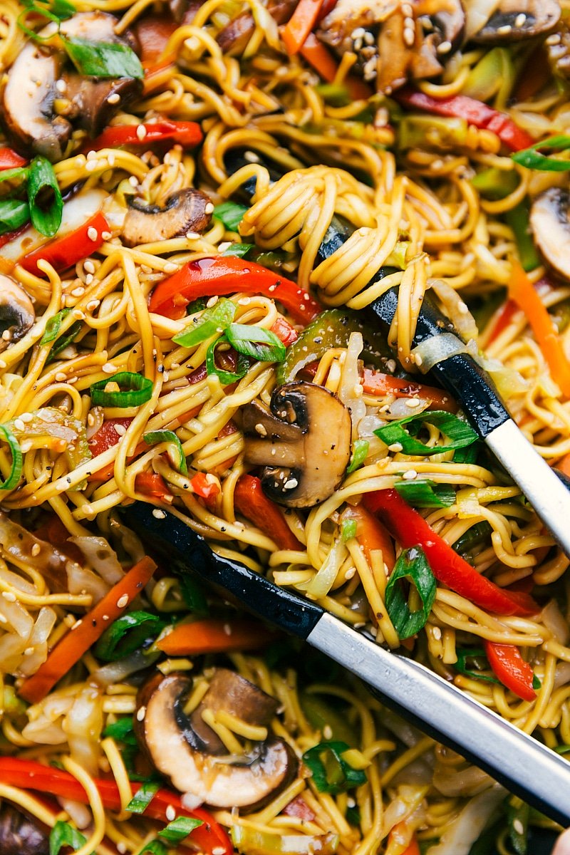 Up-close image of the cooked Chow Mein in a pot with tongs.