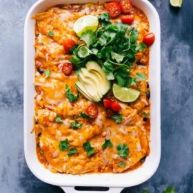 A pan of chicken enchilada casseroles, topped with a generous portion of melted cheese, fresh from the oven.