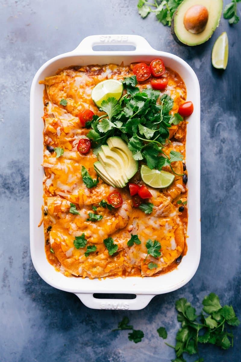 A pan of chicken enchilada casseroles, topped with a generous portion of melted cheese, fresh from the oven.