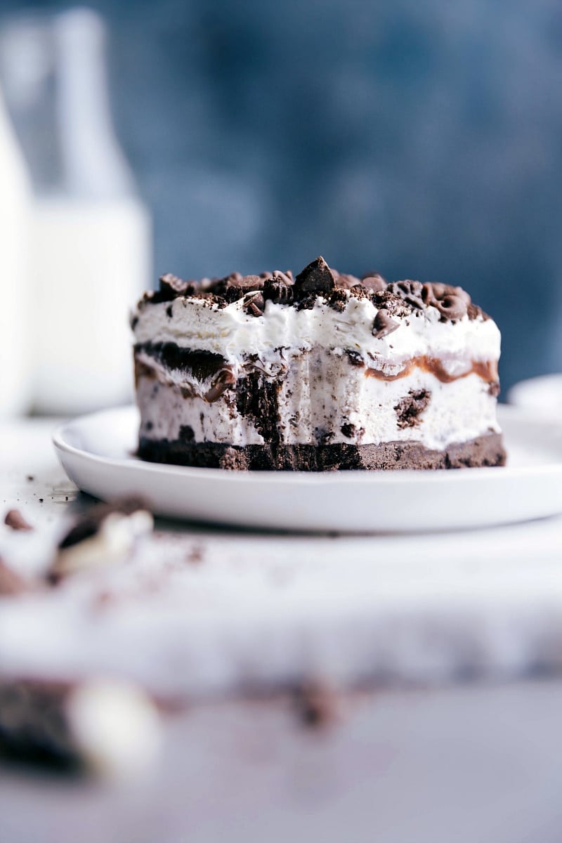 Slice of frozen dessert on a plate with a bite taken, revealing the scrumptious layers within.