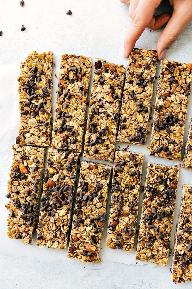 Overhead shot of Homemade Granola Bars, with a hand reaching to take one.