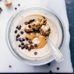 Peanut butter cookie overnight oats with a beautiful peanut butter swirl in it and mini cookie dough balls on top.