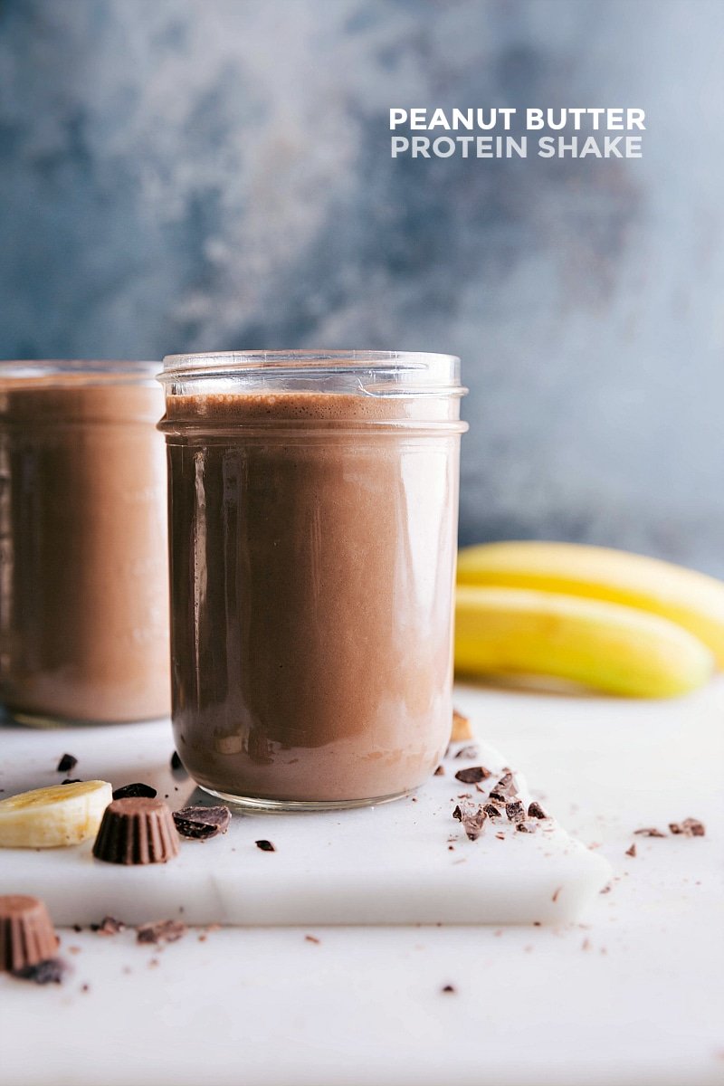 Image of Peanut Butter Protein Shake with fresh bananas and peanut butter cups on the side.