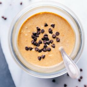 Pumpkin overnight oats topped with chocolate chips, prepared and ready for on-the-go enjoyment.