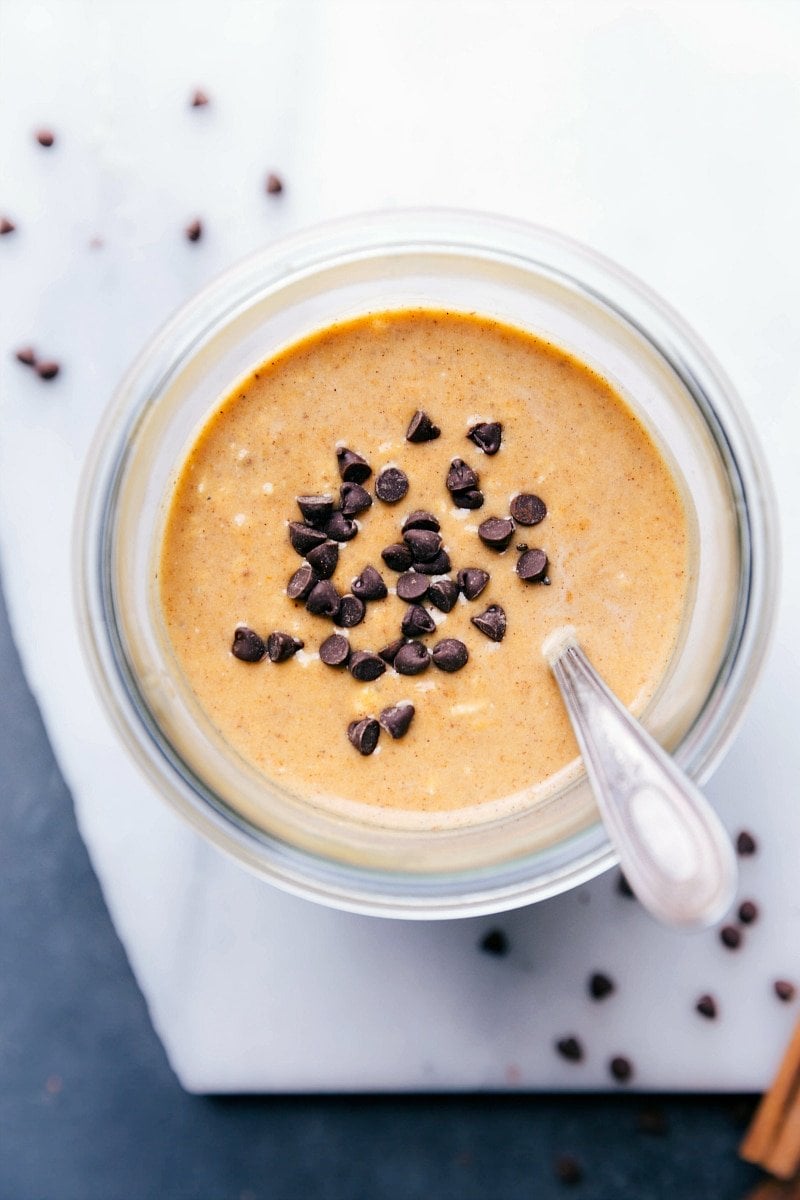 Pumpkin overnight oats topped with chocolate chips, prepared and ready for on-the-go enjoyment.