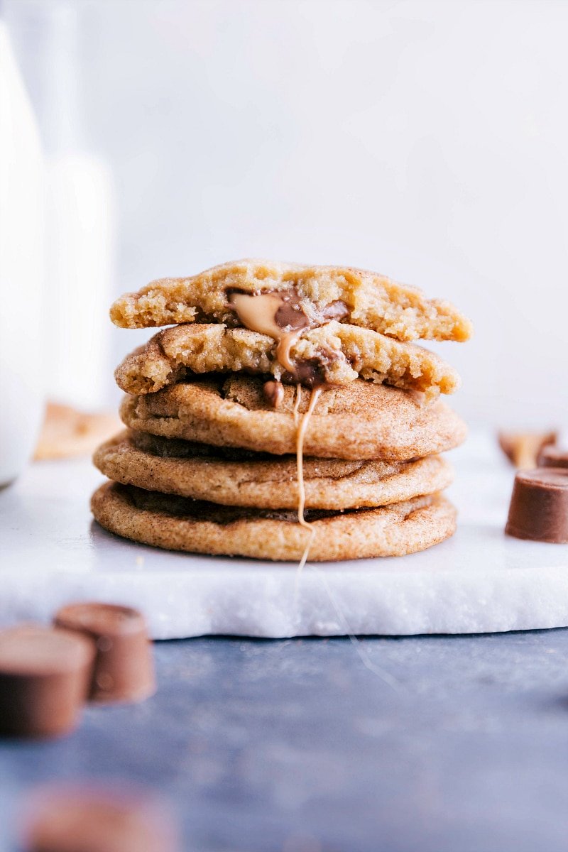 Image of Caramel Snickerdoodles stacked on top of each other with one broken in half showing the inside.