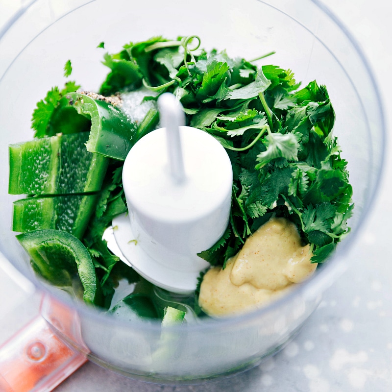 Process shot-- Image of the cilantro-lime vinaigrette being made in a mini food processor.