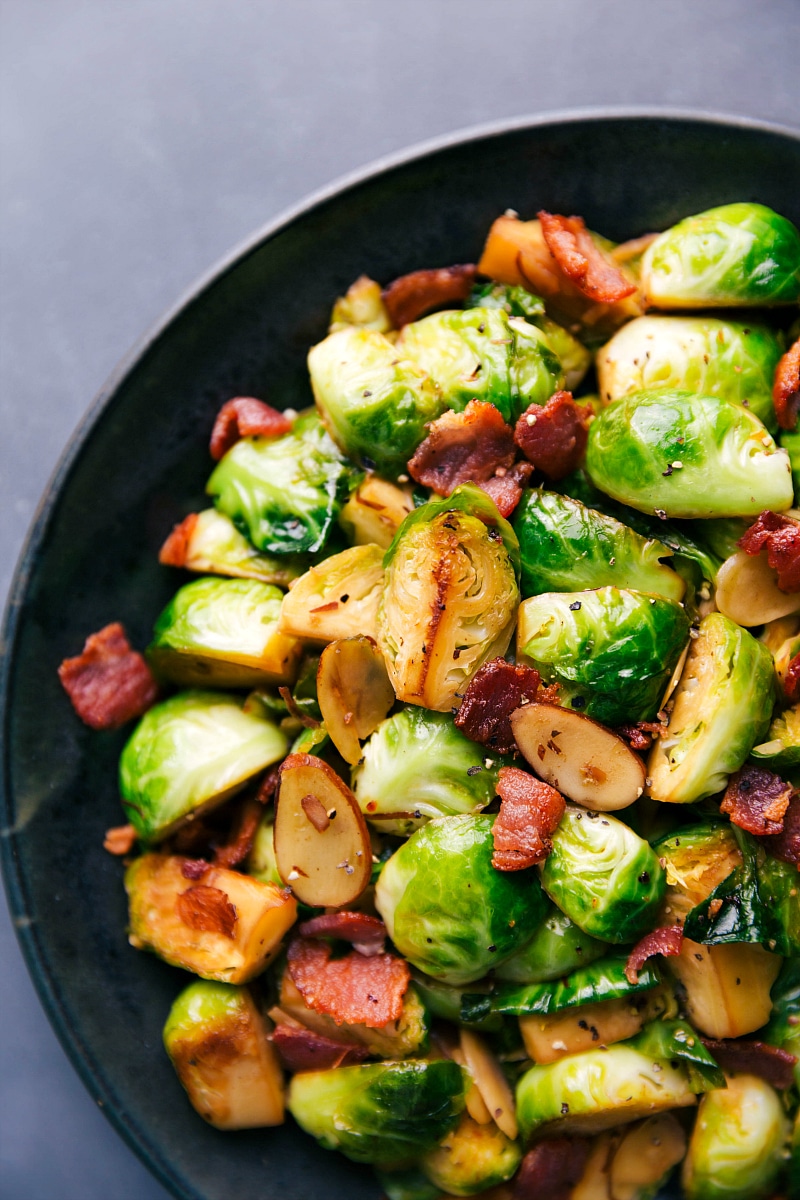 Up-close overhead image of Brussels sprouts and Bacon on a plate, ready to be eaten.