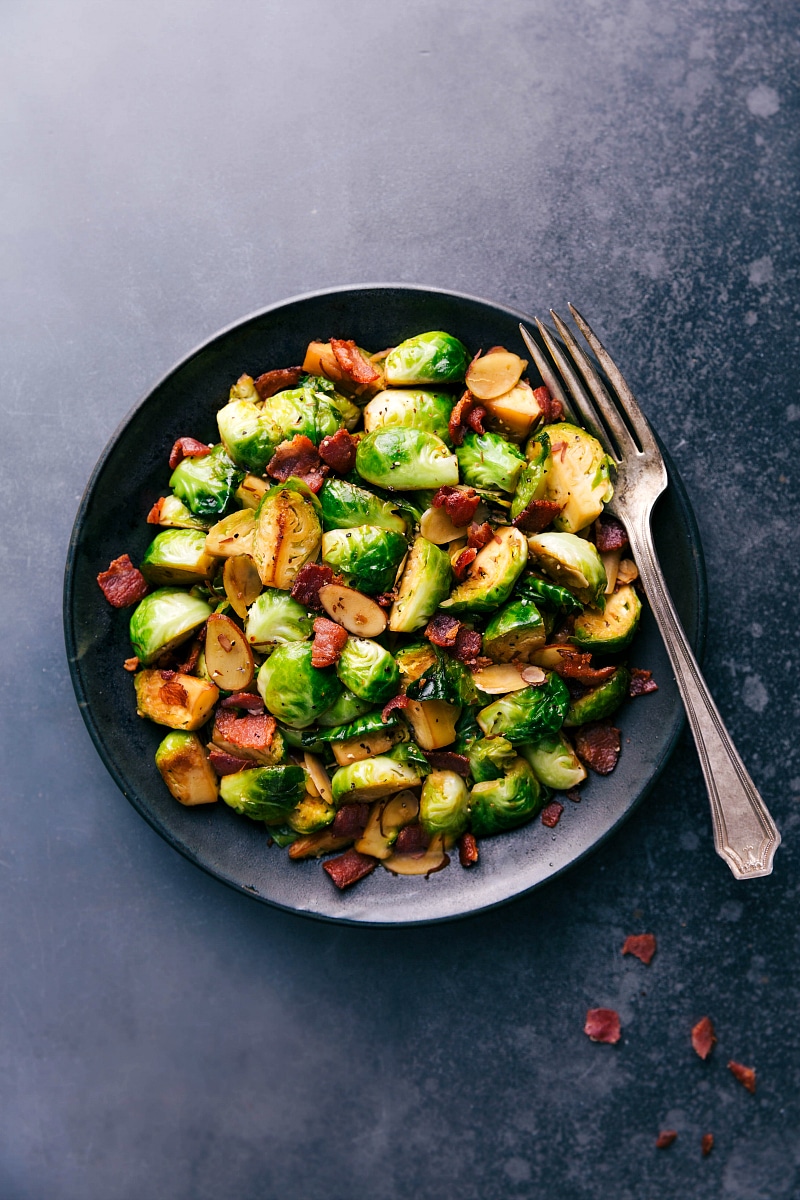 Brussels sprouts and bacon on a plate, cooked to perfection and ready to be enjoyed.