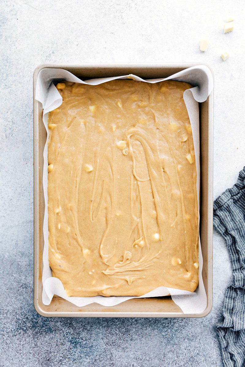 Image of the white chocolate snickerdoodle blondies dough being added into the pan