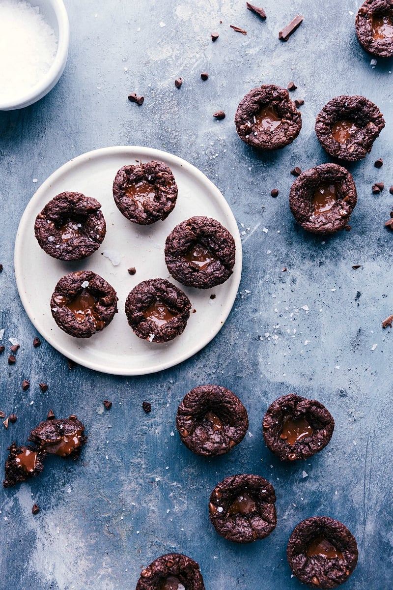 Plate filled with freshly baked mini brownie bites, their centers oozing with molten chocolate.