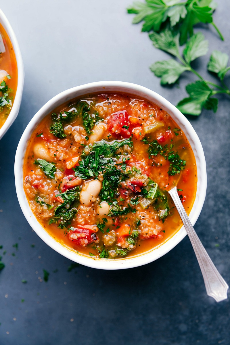 Overhead image of the white bean and kale soup with a spoon in it