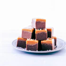 Microwave Fudge cut into cubes and stacked on a plate.