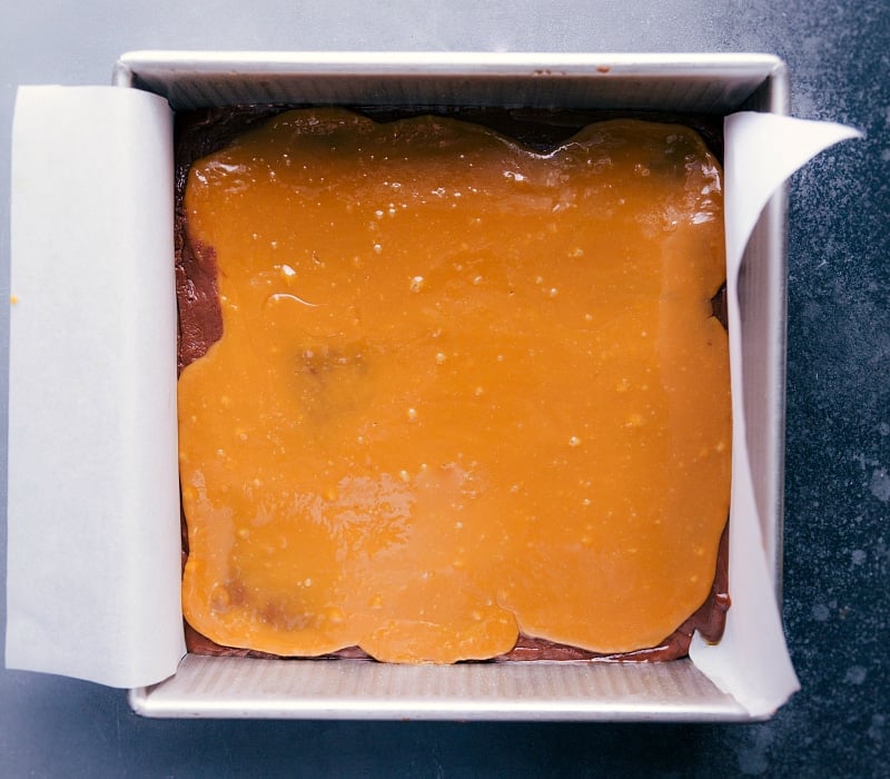 Microwave Fudge with caramel spread evenly on top.