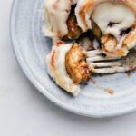 Homemade Cinnamon Roll with bite taken out of it.