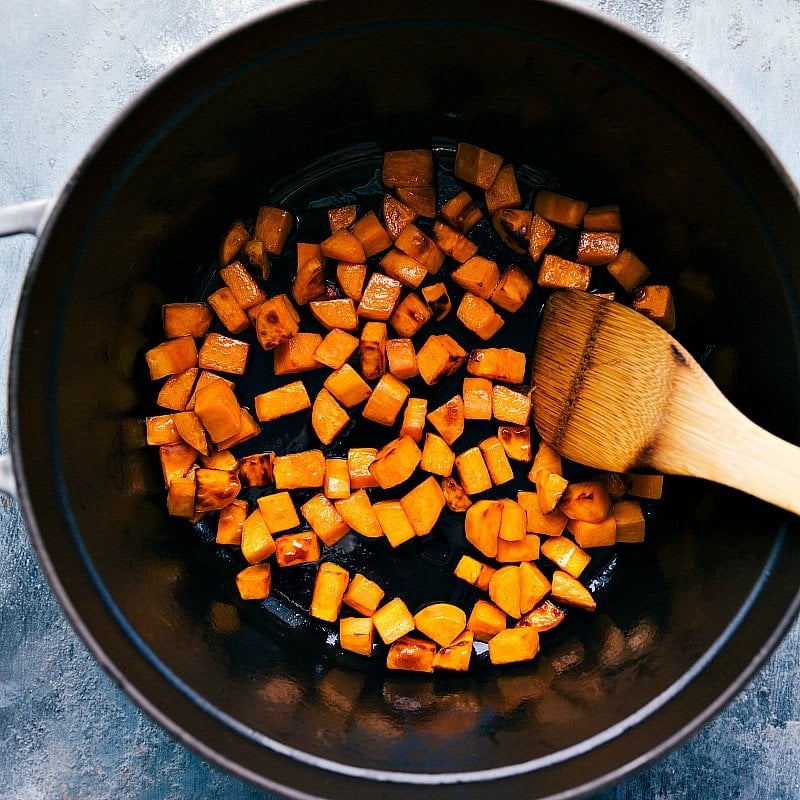 Sweet potatoes cooking in a pot, a key step in the preparation of sweet potato quinoa chili.