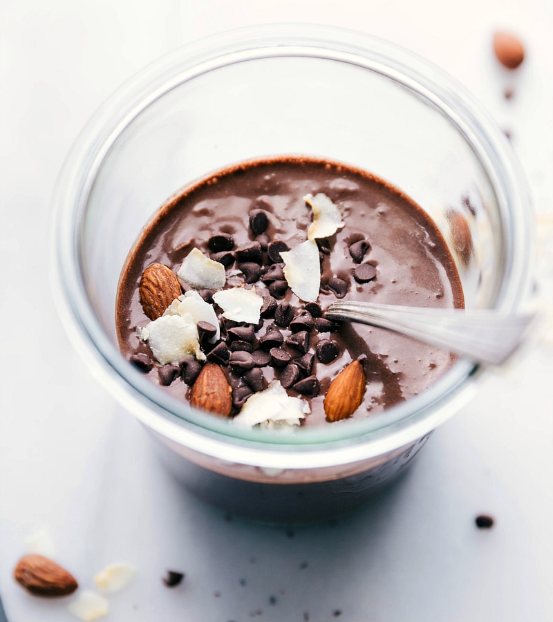 Images of Almond Joy Overnight Oats with in a spoon in it, ready to be eaten.