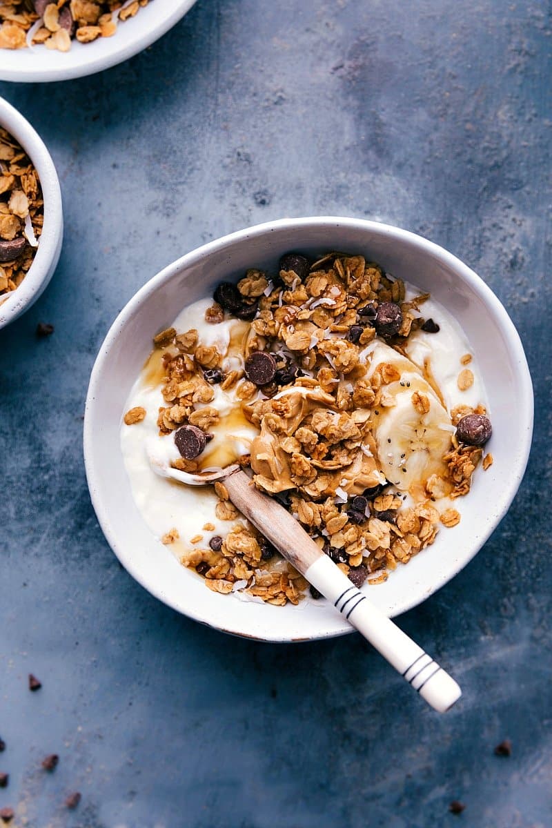 Bowl of creamy yogurt topped with Peanut Butter Granola, ready to be enjoyed.