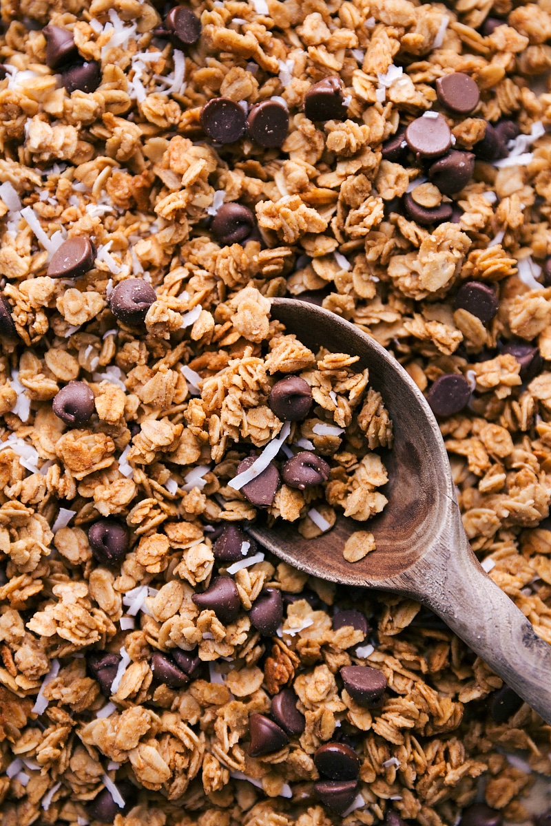 Overhead image of Peanut Butter Granola recipe on a tray with a spoon in it.