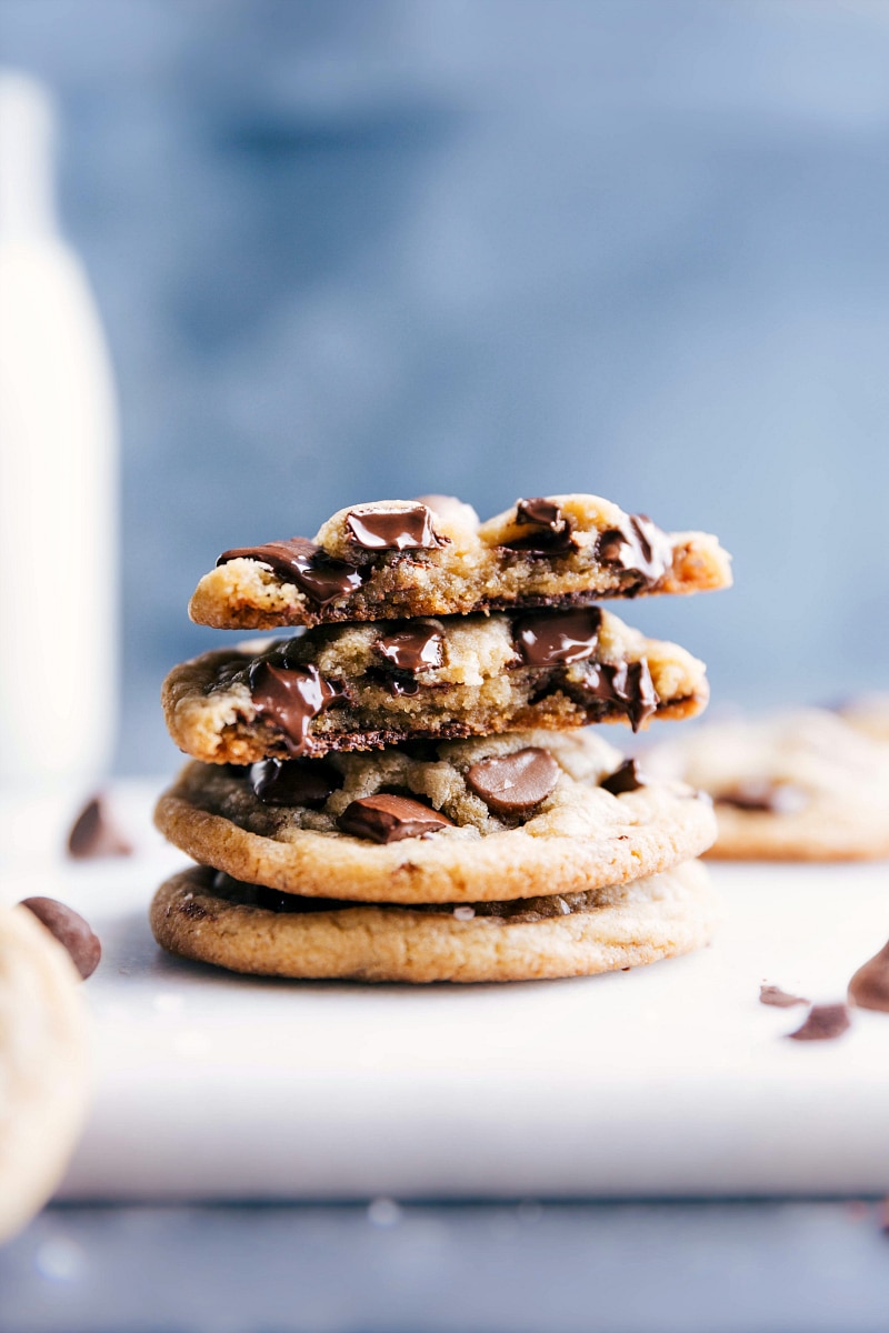 Small batch chocolate chip cookies stacked, with one cookie broken open revealing gooey, melting chocolate inside.