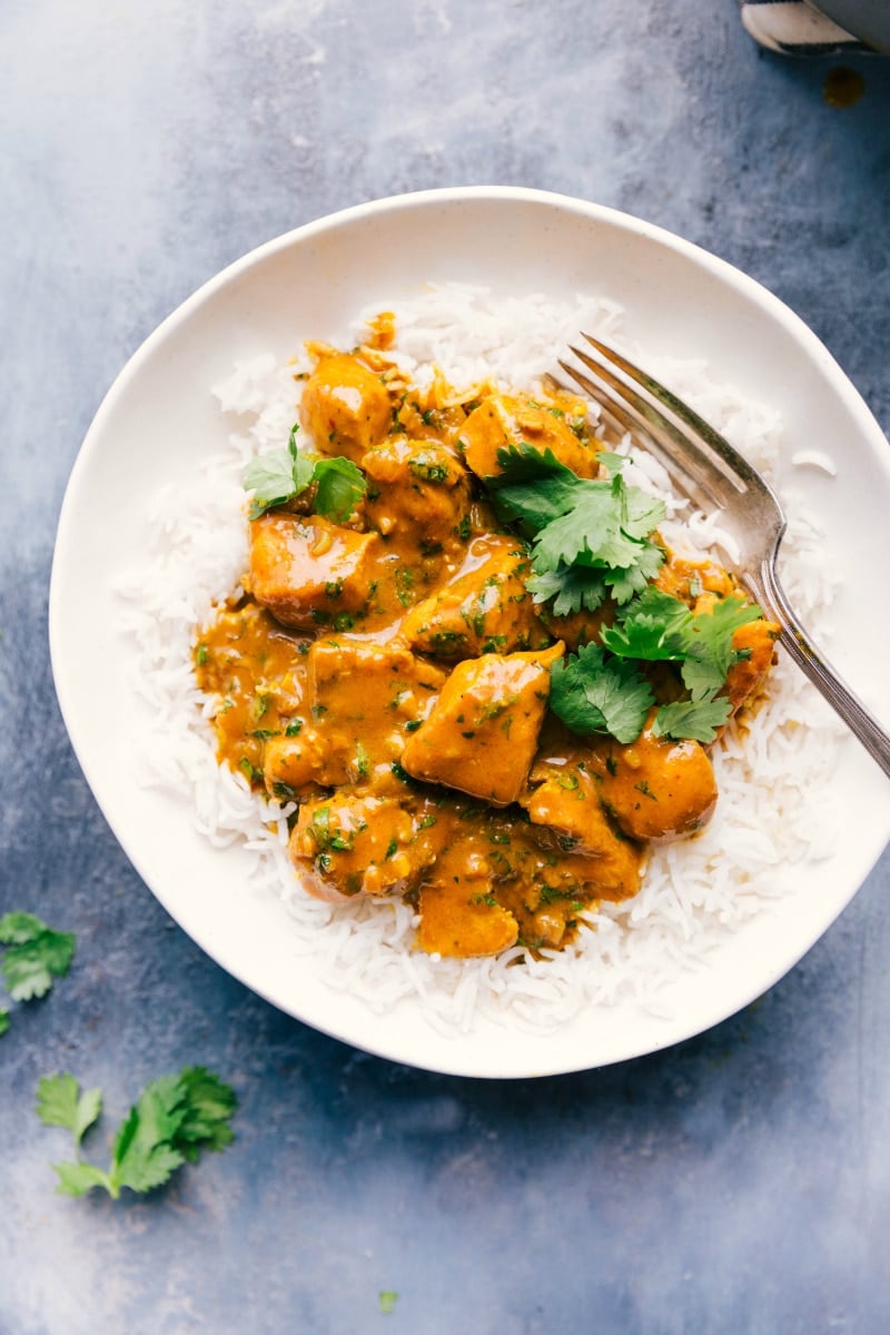 Overhead image of Chicken Curry over rice in a bowl, with a fork on the side.