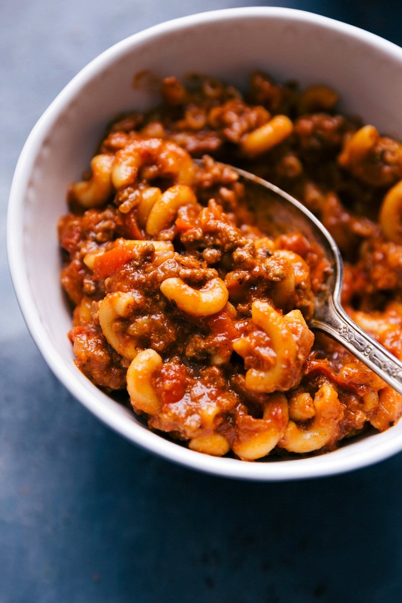 Bowl of american goulash with a spoon, ready to serve.