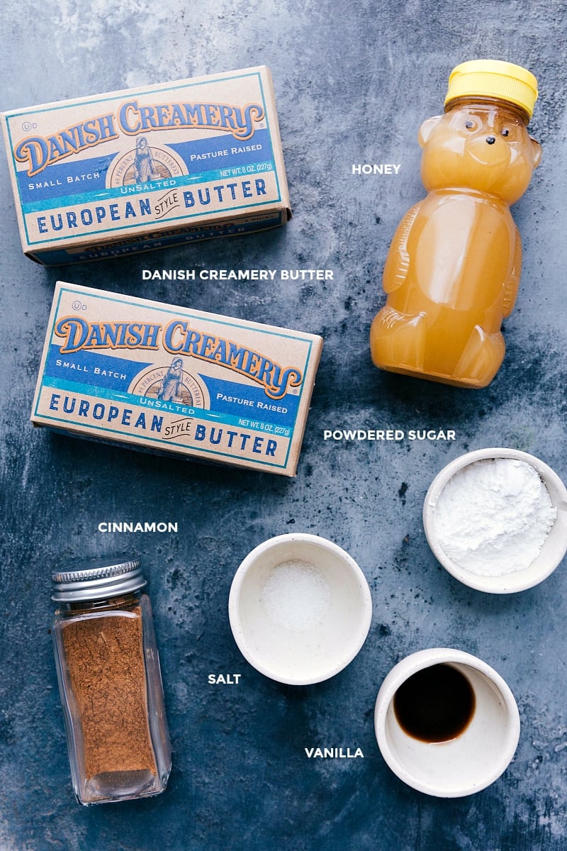 View of the ingredients for Honey Butter: butter, honey, powdered sugar, vanilla, salt and cinnamon.